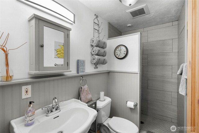 418 Summer Pl SW, Mattawa, WA 99349 - bathroom with a sink, toilet, a shower stall, and wainscoting