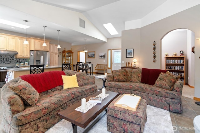 252 Mariners Dr, Sequim, WA 98382 - living room featuring lofted ceiling, arched walkways, light tile patterned flooring, and recessed lighting