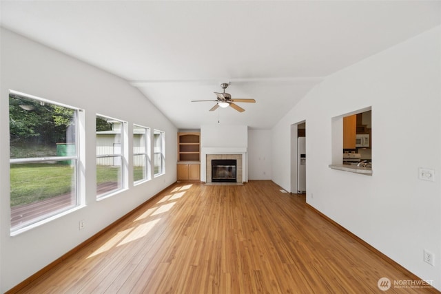 824 Cherub Pl E, Port Orchard, WA 98366 - unfurnished living room featuring lofted ceiling, light wood-style floors, healthy amount of natural light, and a ceiling fan