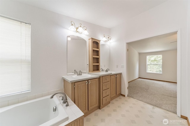 824 Cherub Pl E, Port Orchard, WA 98366 - bathroom with double vanity, a garden tub, and baseboards