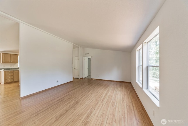 824 Cherub Pl E, Port Orchard, WA 98366 - empty room featuring lofted ceiling, light wood-style floors, and baseboards