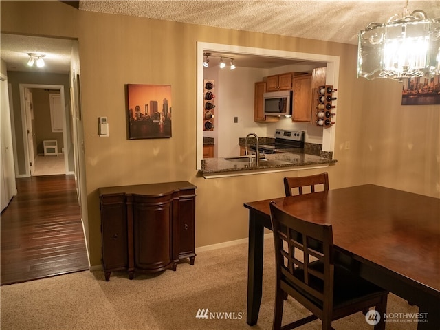12840 SE 40th Ct Unit B12, Bellevue, WA 98006 - dining room with a chandelier, a textured ceiling, and baseboards