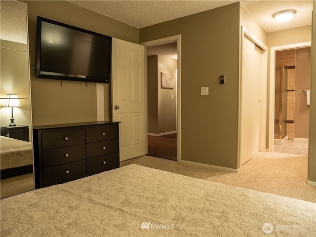 12840 SE 40th Ct Unit B12, Bellevue, WA 98006 - carpeted bedroom featuring a textured ceiling, a closet, and baseboards