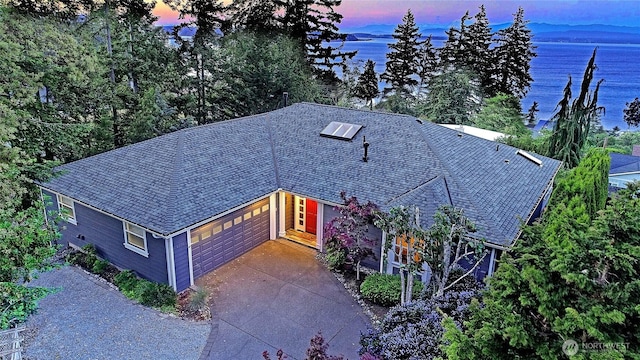 1351 Crestview Dr, Camano Island, WA 98282 - view of front of home featuring driveway, an attached garage, and a water view