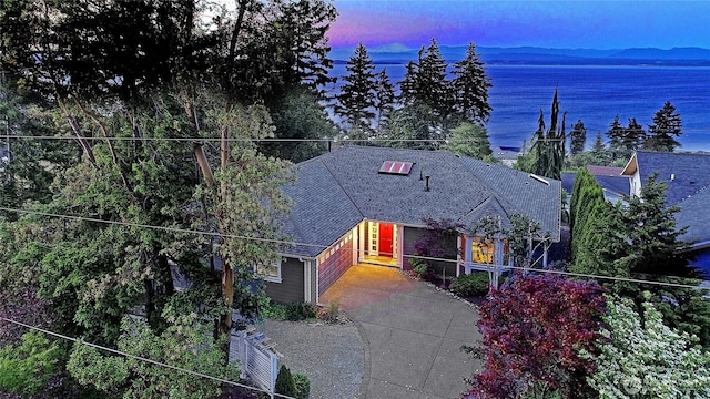 1351 Crestview Dr, Camano Island, WA 98282 - view of front of property featuring driveway, a water view, a garage, and a shingled roof