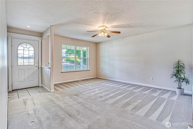 1718 6th St SE, East Wenatchee, WA 98802 - carpeted foyer entrance with healthy amount of natural light, ceiling fan, baseboards, and a textured ceiling
