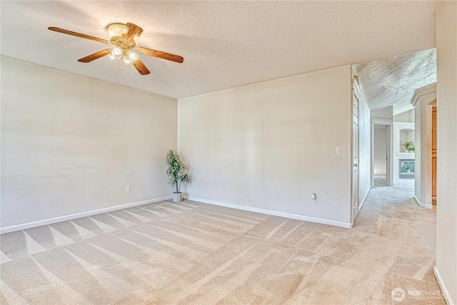 1718 6th St SE, East Wenatchee, WA 98802 - unfurnished room featuring light carpet, a ceiling fan, a textured ceiling, and baseboards