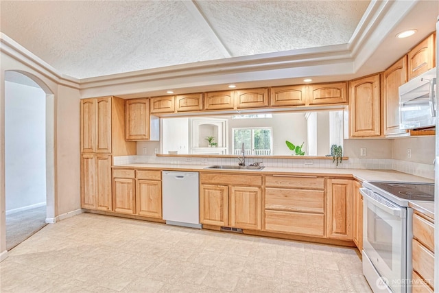1718 6th St SE, East Wenatchee, WA 98802 - kitchen with white appliances, a sink, light countertops, light brown cabinets, and recessed lighting