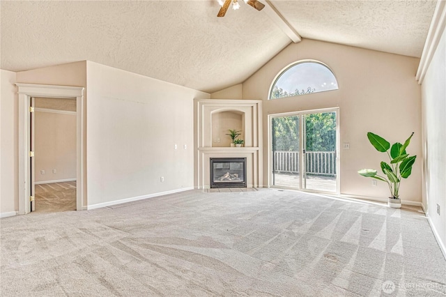 1718 6th St SE, East Wenatchee, WA 98802 - unfurnished living room featuring carpet, a textured ceiling, ceiling fan, a fireplace with flush hearth, and baseboards