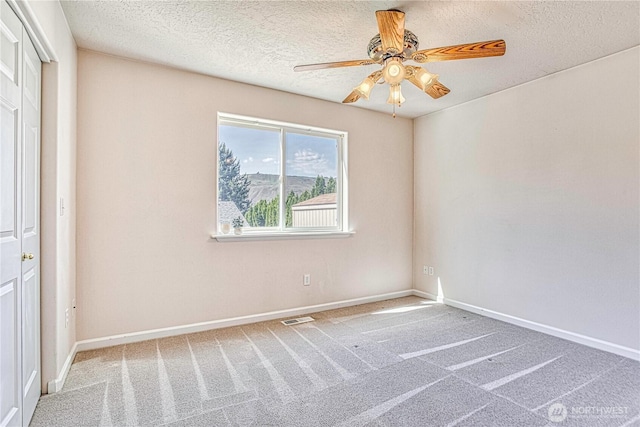 1718 6th St SE, East Wenatchee, WA 98802 - spare room featuring a ceiling fan, carpet, a textured ceiling, and baseboards