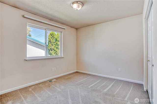 1718 6th St SE, East Wenatchee, WA 98802 - empty room featuring baseboards, carpet floors, and a textured ceiling