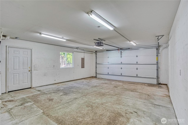 1718 6th St SE, East Wenatchee, WA 98802 - garage featuring a garage door opener and electric panel