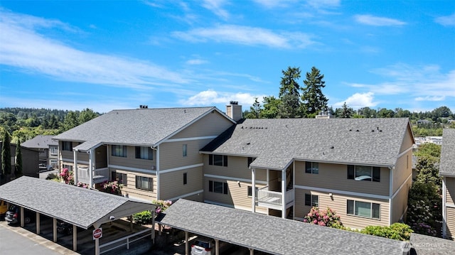 12840 SE 40th Ct Unit A4, Bellevue, WA 98006 - back of house featuring a chimney, a balcony, and a shingled roof