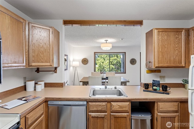 12840 SE 40th Ct Unit A4, Bellevue, WA 98006 - kitchen with dishwasher, a sink, a peninsula, and light countertops