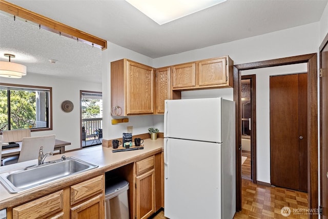 12840 SE 40th Ct Unit A4, Bellevue, WA 98006 - kitchen featuring freestanding refrigerator, a sink, and light countertops