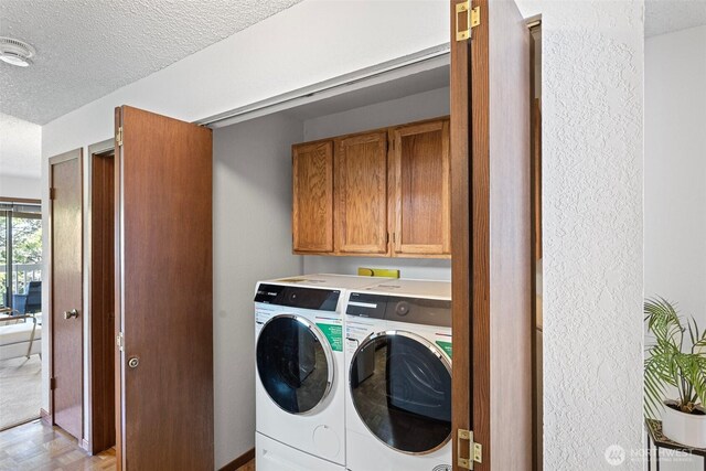 12840 SE 40th Ct Unit A4, Bellevue, WA 98006 - washroom featuring washer and clothes dryer, a textured ceiling, and cabinet space