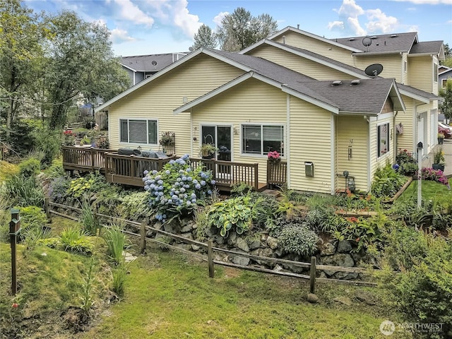 6511 127th Street Ct E Unit 19, Puyallup, WA 98373 - rear view of house featuring a wooden deck, a shingled roof, and a lawn