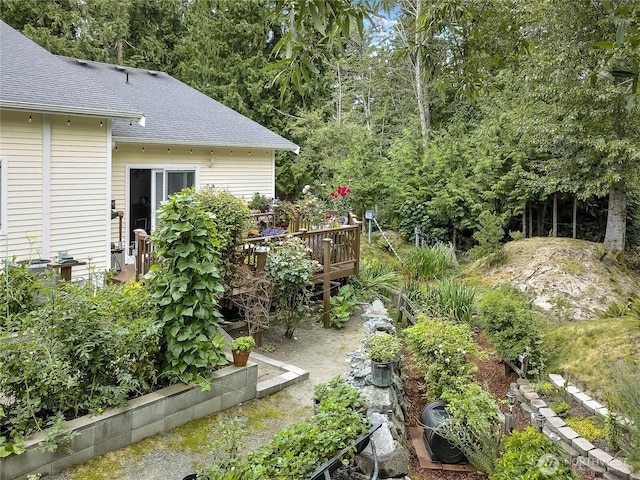 6511 127th Street Ct E Unit 19, Puyallup, WA 98373 - view of yard featuring a wooden deck and a vegetable garden