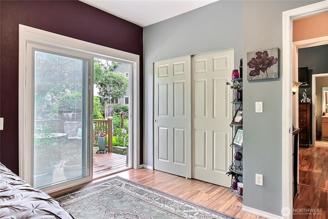 6511 127th Street Ct E Unit 19, Puyallup, WA 98373 - bedroom with access to outside, light wood-style flooring, a closet, and baseboards