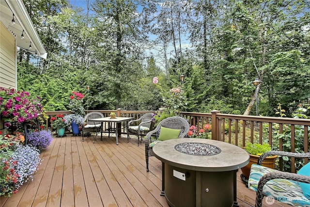 6511 127th Street Ct E Unit 19, Puyallup, WA 98373 - wooden deck featuring outdoor dining area and view of wooded area