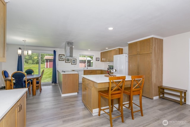 21709 Jordan Rd, Arlington, WA 98223 - kitchen featuring white appliances, island exhaust hood, light countertops, light wood-style flooring, and recessed lighting