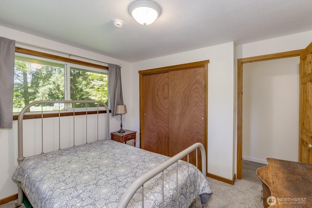 21709 Jordan Rd, Arlington, WA 98223 - bedroom featuring baseboards, a closet, and light carpet