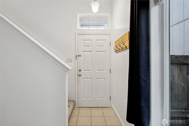 8906 161st St E, Puyallup, WA 98375 - doorway featuring light tile patterned flooring, stairway, and baseboards