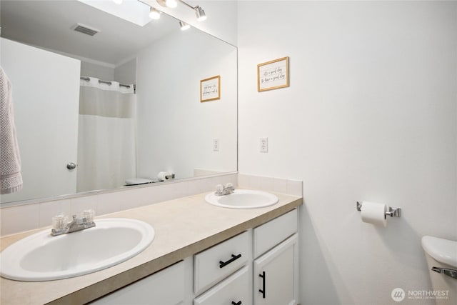 8906 161st St E, Puyallup, WA 98375 - full bath with double vanity, toilet, and a shower with curtain