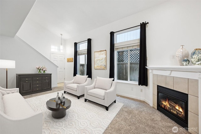 8906 161st St E, Puyallup, WA 98375 - carpeted living room with a fireplace, baseboards, and lofted ceiling