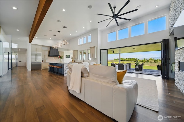126 Red Hawk Rd, Walla Walla, WA 99362 - living room with a ceiling fan, dark wood-type flooring, a towering ceiling, a fireplace, and recessed lighting