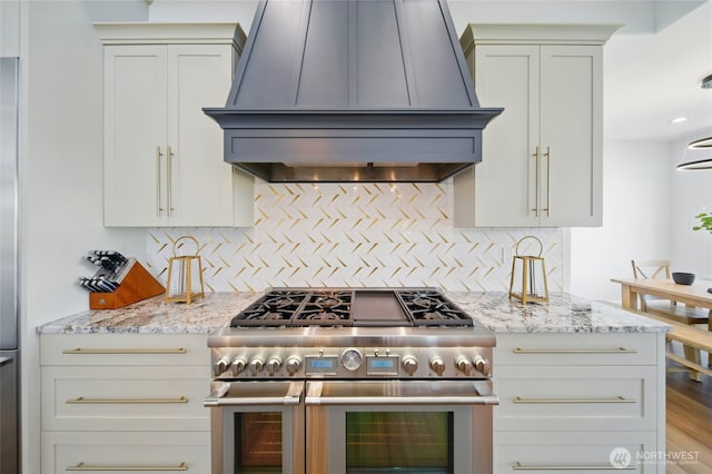 126 Red Hawk Rd, Walla Walla, WA 99362 - kitchen featuring appliances with stainless steel finishes, custom exhaust hood, decorative backsplash, and light stone counters
