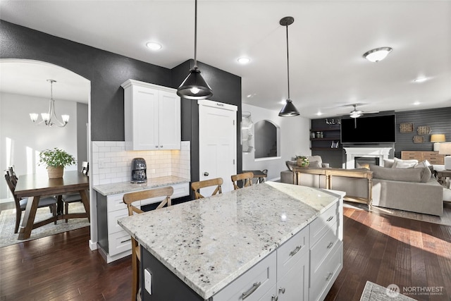 10713 Palisades St SE, Yelm, WA 98597 - kitchen with arched walkways, a ceiling fan, dark wood-style floors, and recessed lighting