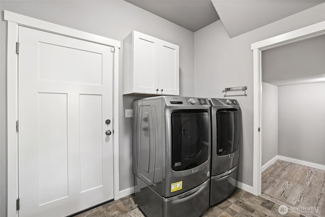 10713 Palisades St SE, Yelm, WA 98597 - laundry area featuring washer and clothes dryer, cabinet space, and baseboards