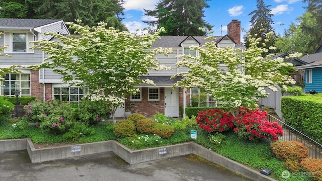 1420 Bellevue Way SE Unit 14, Bellevue, WA 98004 - view of front of property with brick siding, a chimney, and uncovered parking