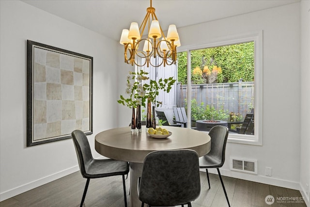 1420 Bellevue Way SE Unit 14, Bellevue, WA 98004 - dining area featuring a chandelier, baseboards, and wood finished floors