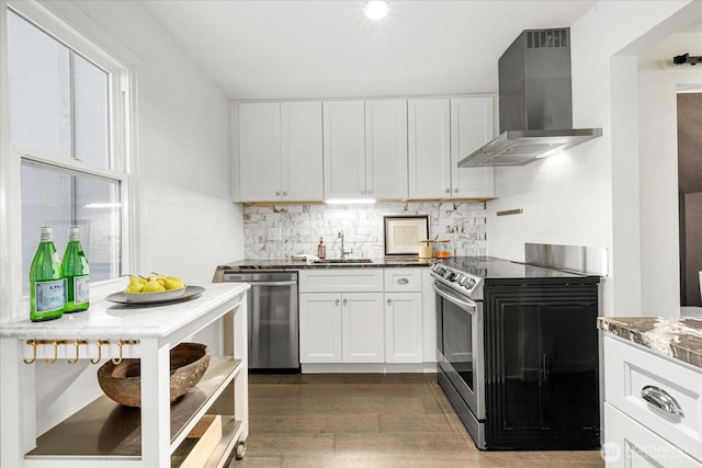 1420 Bellevue Way SE Unit 14, Bellevue, WA 98004 - kitchen with wall chimney range hood, stainless steel appliances, wood finished floors, decorative backsplash, and white cabinetry
