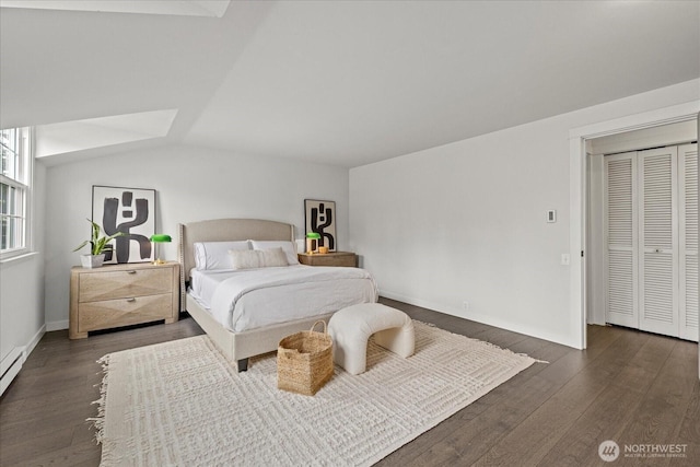 1420 Bellevue Way SE Unit 14, Bellevue, WA 98004 - bedroom with wood finished floors, baseboards, a baseboard heating unit, and lofted ceiling