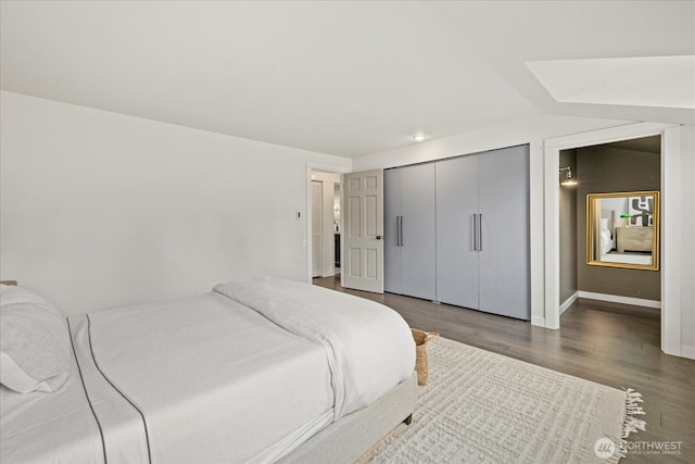 1420 Bellevue Way SE Unit 14, Bellevue, WA 98004 - bedroom with wood finished floors, a closet, and baseboards