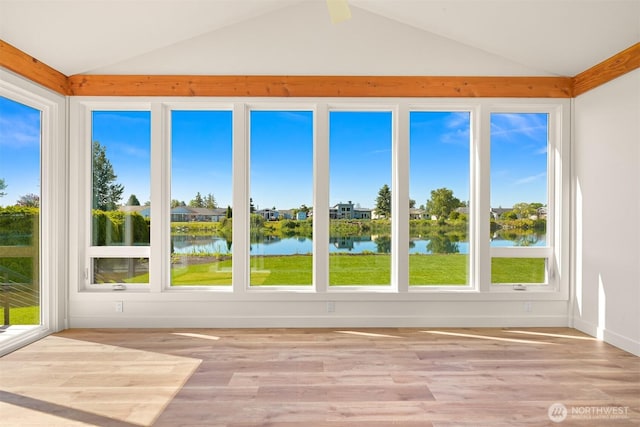 5425 Salish Rd, Blaine, WA 98230 - unfurnished sunroom featuring vaulted ceiling, a water view, plenty of natural light, and wood finished floors