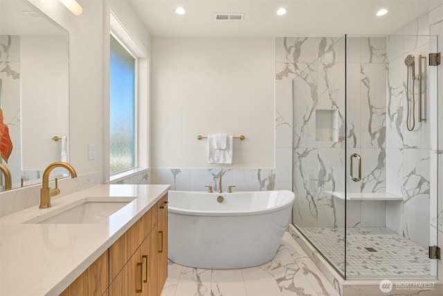 5425 Salish Rd, Blaine, WA 98230 - full bathroom with marble look tiles, recessed lighting, a marble finish shower, a soaking tub, and vanity