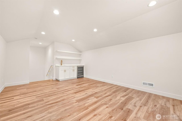 5425 Salish Rd, Blaine, WA 98230 - bonus room featuring beverage cooler, vaulted ceiling, recessed lighting, light wood finished floors, and baseboards
