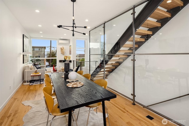 3852 Beach Dr SW Unit A, Seattle, WA 98116 - dining space with light wood-type flooring, a wall mounted air conditioner, a chandelier, and recessed lighting