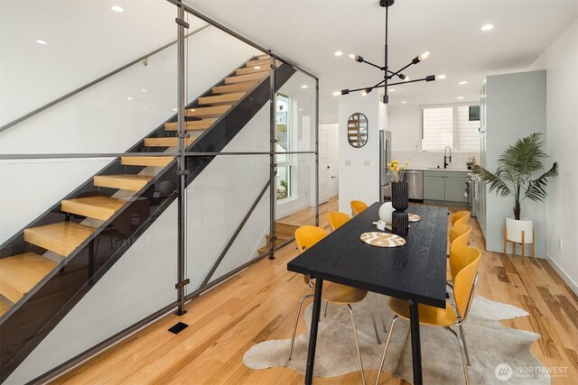 3852 Beach Dr SW Unit A, Seattle, WA 98116 - dining area featuring light wood-style flooring, stairs, recessed lighting, and a chandelier