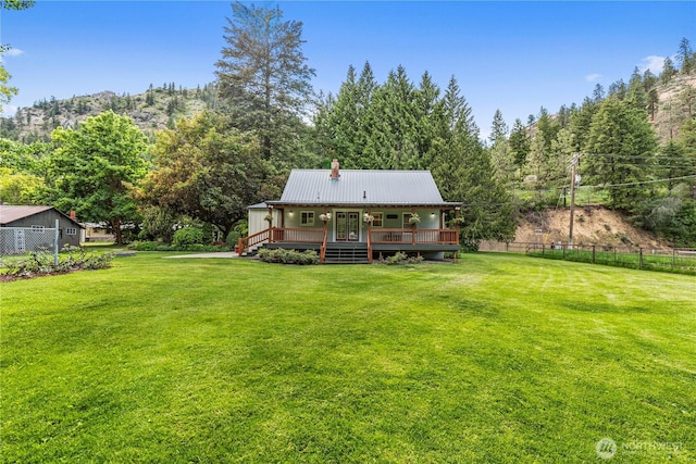 1361 Mission Creek Rd, Cashmere, WA 98815 - back of house with a chimney, a wooden deck, and metal roof