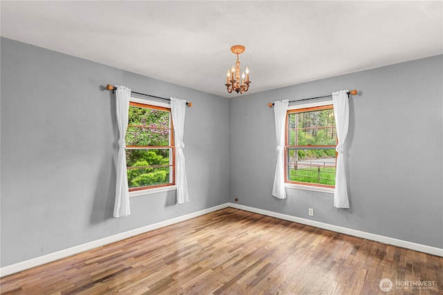 1361 Mission Creek Rd, Cashmere, WA 98815 - spare room with plenty of natural light, baseboards, wood finished floors, and a chandelier