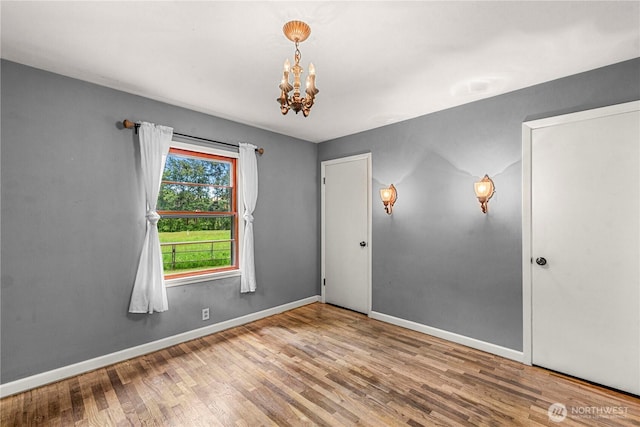 1361 Mission Creek Rd, Cashmere, WA 98815 - unfurnished room with wood finished floors, a chandelier, and baseboards