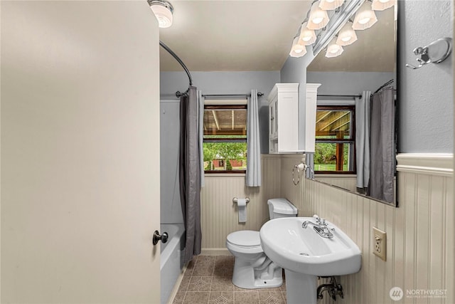 1361 Mission Creek Rd, Cashmere, WA 98815 - full bathroom with tile patterned flooring, a wainscoted wall, toilet, shower / bathtub combination with curtain, and a sink