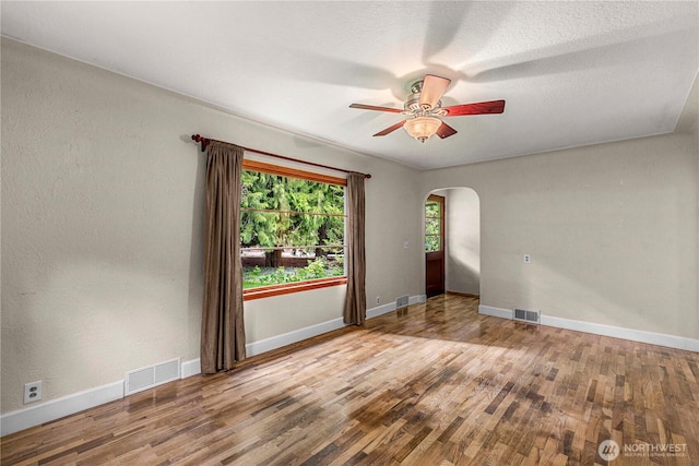 1361 Mission Creek Rd, Cashmere, WA 98815 - unfurnished room with arched walkways, wood finished floors, a ceiling fan, and baseboards