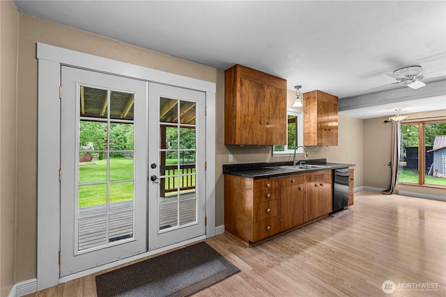 1361 Mission Creek Rd, Cashmere, WA 98815 - kitchen featuring black dishwasher, brown cabinets, a sink, light wood finished floors, and french doors