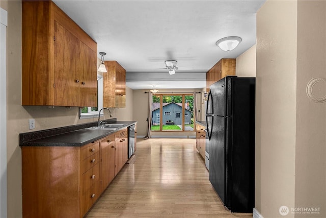 1361 Mission Creek Rd, Cashmere, WA 98815 - kitchen with freestanding refrigerator, a sink, brown cabinets, light wood-style floors, and dishwasher